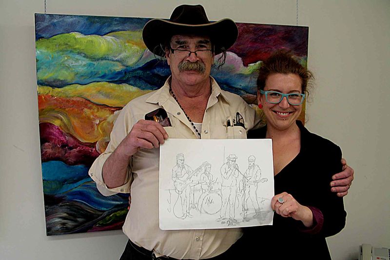 Artist Daniel Lemire (left) and Artbeat employee Rebecca Winkworth display Lemire's sketch of the Sunday night blues jam at Times Change(d). Fourteen Artbeat artists added their own flair to Lemire's sketches for Who's Got Dem Blues? which is on display at Seven Oaks General Hospital.