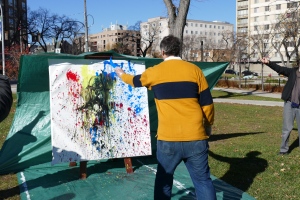 Winnipeggers threw cupfuls of paint onto a large canvas at Central Park on Thursday afternoon. (Jeff Stapleton/CBC)